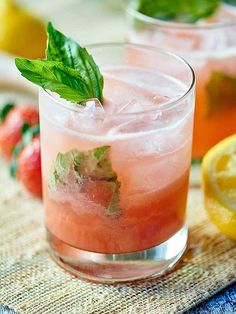 two glasses filled with watermelon lemonade and mint garnish