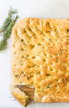 an easy focaccia bread with rosemary sprigs on top and text overlay