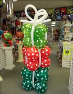 balloons are stacked on top of each other in the shape of bows and polka dots