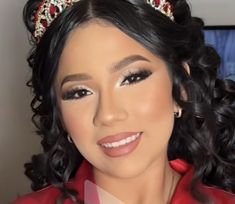 a woman wearing a tiara and smiling at the camera