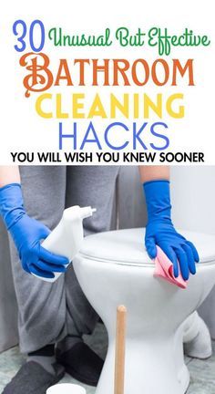 a person cleaning a white toilet with blue gloves and a rag on it's side