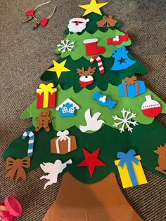 a christmas tree made out of paper on the floor