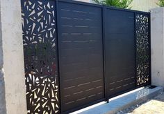 an iron gate with geometric designs on it