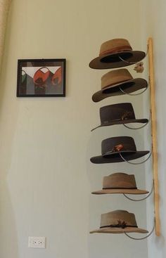 several hats are hanging on the wall