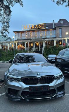 two cars parked in front of a building with a sign that says terrani on it