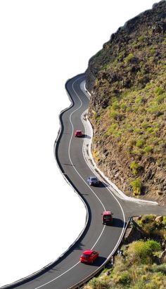 three cars driving down a curved road in the mountains