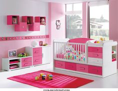 a pink and white baby's room with lots of furniture