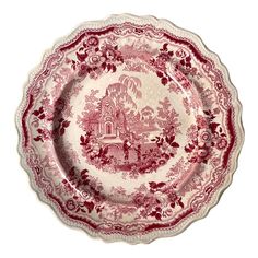 a red and white plate with an image of a castle in the middle of it