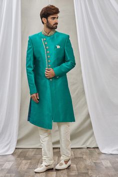 Teal green overlap sherwani with floral placement embroidery and mandarin collar. Paired with churidar.
Component: 2
Pattern: Embroidered
Neckline: Mandarin
Sleeve Type: Full Sleeves
Fabric: Art Banarasi Silk, Dupion Art Silk
Color: Green
Other Details: 
Front buttons
Note: Pocket square worn by the model is not for sale
Occasion: Wedding - Aza Fashions Designer Green Salwar Kameez With Naqshi, Green Straight Kurta Salwar Kameez For Formal Occasions, Formal Green Straight Kurta Salwar Kameez, Formal Green Churidar With Dabka Detailing, Green Traditional Wear With Naqshi For Eid, Green Naqshi Salwar Kameez For Wedding, Green Naqshi Traditional Wear For Eid, Green Naqshi Traditional Wear For Festivals, Formal Green Salwar Kameez With Resham Embroidery