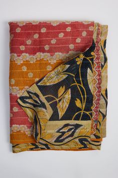 two pieces of cloth are folded on top of each other in different colors and patterns