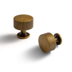 two brass knobs on white background