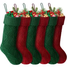 four christmas stockings with ornaments hanging from the top and bottom, all decorated in red green and gold