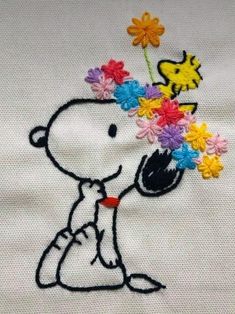 a snoopy with flowers in his mouth