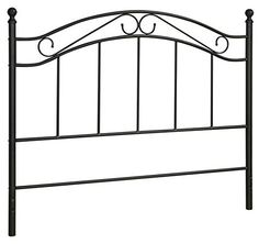 a black metal headboard with four posts