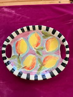 a paper plate with lemons painted on it