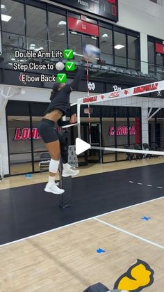 a woman is playing volleyball in an indoor court