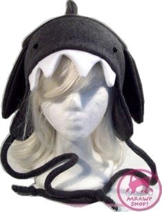 a mannequin head wearing a black and white shark hat