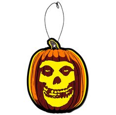 a pumpkin shaped ornament with a scary face on it's front and side