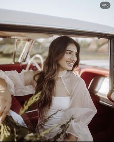 a woman sitting in the back seat of a car