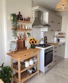 a kitchen with an oven, stove and shelves on the wall