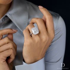 a woman wearing a diamond ring on her finger