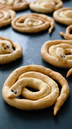 some cookies are shaped like spirals on a cookie sheet with holes in the middle