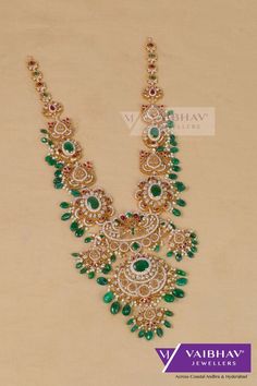 Elegant designs of gold harams are seen on our jewellery site to shop and ship we have skilled jewellery experts ready to assist you on the jewellery needs. Own this long v neck stone pachi worked gold haram made of 22 karat pure gold. Emerald beads are togethered with 22 karat gold to design this long haram for women's marriage and other grand occasions with great appearance. #goldjewellery #gold #diamond #diamondjewellery #goldharamdesigns #haramdesignslatest #latestharamdesigns #weddingharamdesigns #bridalharamdesigns #uniquejewellery #marriagejewellery #weddingjewellery #diamondlongnecklace #longnecklace #costofgoldharam #realdiamondjewellery #trendingharamdesigns #attractiveharams #sparklingharamdesigns #weddingreceptionjewellery #onlinejewelleryshopping #livevideoshopping Gold Haram Designs, Marriage Jewellery, Aesthetic Letters, Emerald Bead