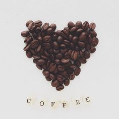 coffee beans arranged in the shape of a heart with words written on them that spell out coffee