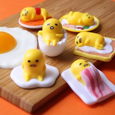 eggs, ham, and other food items on a cutting board with an egg in the middle