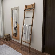 a wooden ladder leaning against a wall next to a mirror