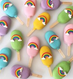 rainbow lollipops with marshmallows on them arranged in a circle