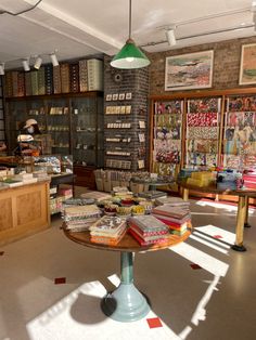 a room filled with lots of books on top of a table