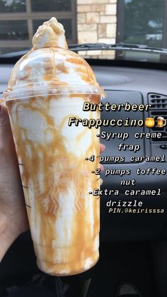 a person holding up a drink in their hand with the caption, butterbeeer frappuccino creme