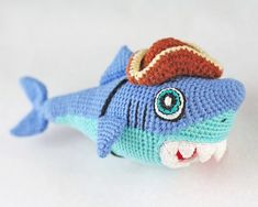 a knitted toy shark with a hat on its head