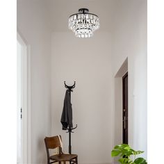 a room with a chair, umbrella and chandelier hanging from the ceiling in it