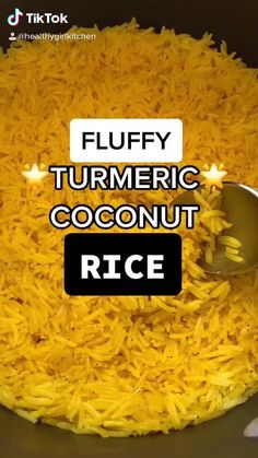 fluffy turmeric coconut rice in a bowl with a spoon on the side and text overlay that reads, fluffy turmeric coconut rice