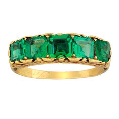 A Victorian five stone emerald carved half hoop ring, the ring set with five square emerald-cut emeralds, estimated to weigh a total of 1.7 carats, all claw-set to an ornate scroll carved yellow gold gallery and shoulders, all to a tapered D-section yellow gold shank, marked 'Ian 10.1902', gross weight 4.9 grams, circa 1890. The finger size of most of our rings can be adjusted and our workshop will be happy to do this free of charge. If you do not know your finger size please request us to post Jewelry Extravagant, Edwardian Rings, Emerald Stone Rings, Gold Gallery, Magnificent Jewels, High Jewellery, Ruby Diamond Rings, Victorian Rings, Jewel Box