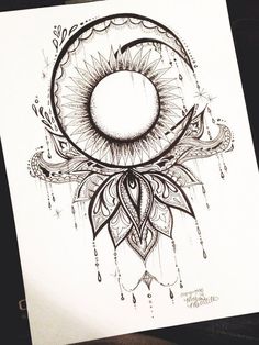 a drawing of the moon and sun with an intricate design on it's side