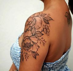 a woman with a flower tattoo on her shoulder