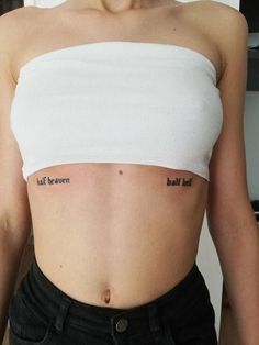 a woman with two small tattoos on her stomach and one has the words half heaven