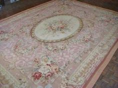 an antique rug is on the floor in a room