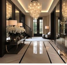 an elegant hallway with chandeliers and white flowers