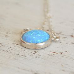 Blue Opal Pendant Necklace,Opal silver Necklace,Gemstone Necklace,Opal Necklace,Gift for Mom,Delicate Necklace,Blue Opal Necklace JewelrySpacial Gift!So dainty and classic tiny everyday opal necklace, great idea for Mother's Day.Beautiful 10mm lab opal pendant hangs on a delicate sterling silver chain .The Opal is October birthstone and considered to be the stone for luck :)This necklace is perfect for yourself, giving as a special gift, or bridesmaid necklaceSo simple and yet will be stunning on your neck!*Model wearing 16 inch length*Opal stone size- 10mm All my jewelry are packed in an elegant gift box.If you want to give it as a gift you can specify the address and I'll be happy to send it on your behalf. Opal Birthstone Necklaces, Opal Birthstone Round Necklaces, Round Opal Birthstone Necklaces, Blue Opal Nickel-free Jewelry, Nickel-free Blue Opal Jewelry, Round Opal For Jewelry Making, Blue Opal Gemstone Necklaces, Blue Opal Pendant Jewelry, Blue Opal Gemstone Necklace