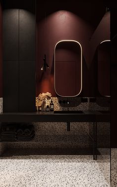 a bathroom with a sink, mirror and towel rack in it's center area