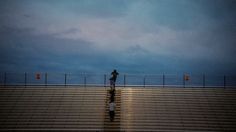 a person is standing on the bleachers at night