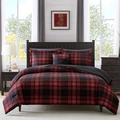 a red and black plaid comforter set in a bedroom with two lamps on either side of the bed