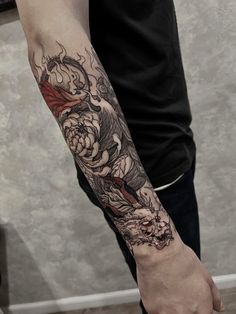 a man with a dragon tattoo on his arm