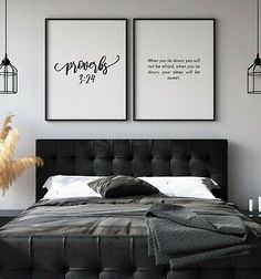 a bedroom with two pictures hanging above the bed