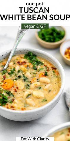 a bowl of soup with broccoli and carrots in it, on top of a table