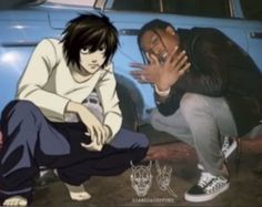 two young men sitting on the ground next to each other in front of a car